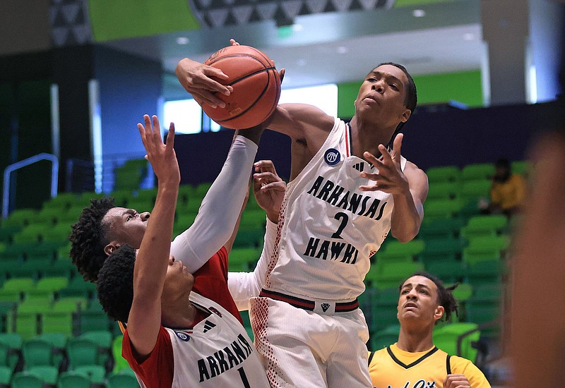 Collin Flanigan (2) of the Arkansas Hawks pulls down a rebound Friday in front of three other players during the Hawks’ 51-46 victory over Grind City Elite during the opening round of the Real Deal in the Rock at Little Rock Southwest High School.
(Arkansas Democrat-Gazette/Colin Murphey)