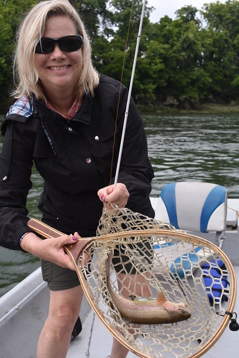 Kathleen Anderson of San Francisco shows off one of the rainbow trout she caught Sunday while fishing with her son Patrick Anderson on the White River near Buffalo City.
(Arkansas Democrat-Gazette/Bryan Hendricks)