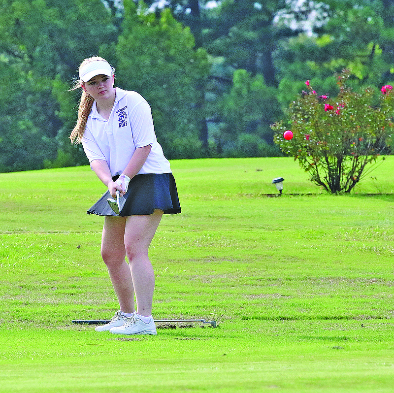 Junction City's Addison Carey hits a shot during action last season. The Lady Dragons and Dragons are scheduled to start the high school golf season next week.