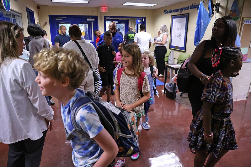 Students arrive for the first day of classes at Gibbs International Magnet School in Little Rock on Monday, Aug. 14, 2023. See more photos at arkansasonline.com/815firstday/ (Arkansas Democrat-Gazette/Colin Murphey)