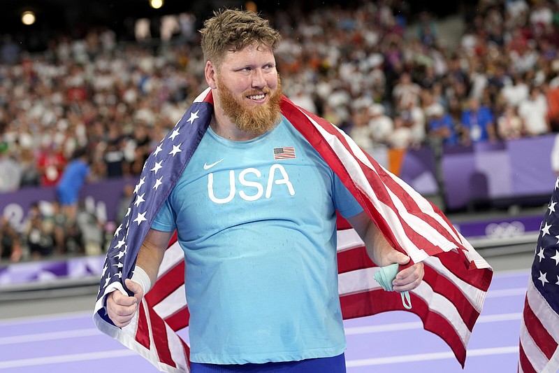 Ryan Crouser, of the United States reacts after winning the men's shot put final at the 2024 Summer Olympics, Saturday, Aug. 3, 2024, in Saint-Denis, France. (AP Photo/Bernat Armangue)