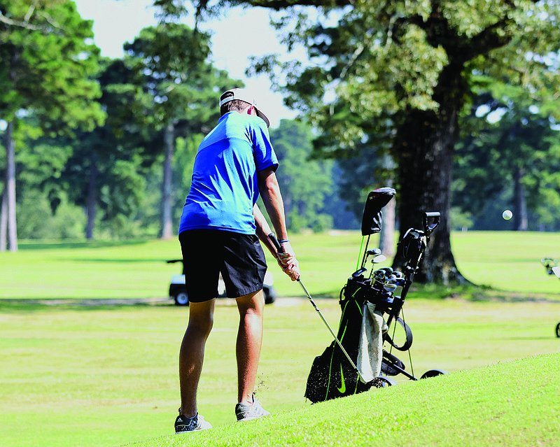 Parkers Chapel's John Hall chips onto the green during action last week at the Lion's Club. The Trojans will play Monday, Tuesday and Wednesday this week.