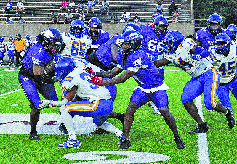 El Dorado's Jakori Lumsey looks for running room in Friday's scrimmage against North Little Rock at Memorial Stadium.