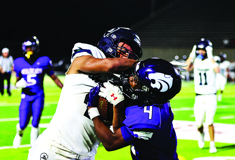 El Dorado cornerback Jarondy Williams battles with a Little Rock Christian defender on Friday. The Wildcats will host Camden Fairview this week at Memorial Stadium.