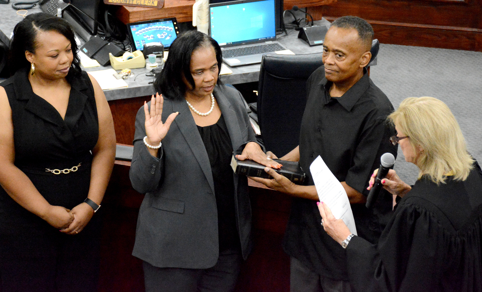 Staff Photo by Robin Rudd / Chancellor Pamela Fleenor, right, administers the oath of office to Jackie Anderson-Thomas. Anderson Thomas is joined by daughter, Jessica Thomas and Ricky Anderson. The six members of the Hamilton County school board who were elected in August were sworn in and administered their Oaths of Office on September 4, 2024. The members were Steve Slater, Ben Daugherty, Jackie Anderson-Thomas, Jodi Schaffer, Felice Hadden and Jill Black.
