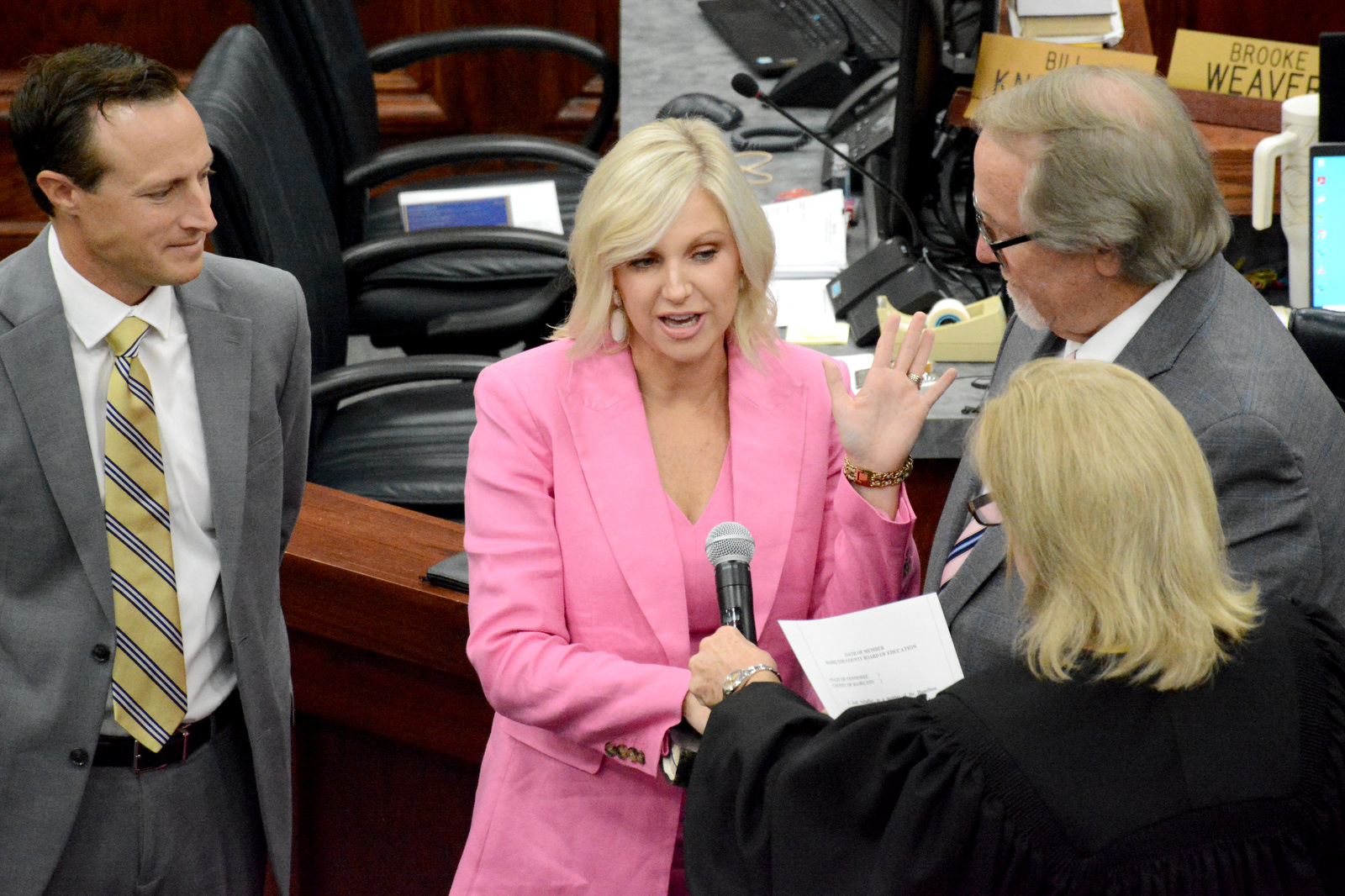 Staff Photo by Robin Rudd / Chancellor Pamela Fleenor, right, administers the oath of office to Jodi Schaffer, as husband, Darald Schaffer and father Rev. Terry Harris, look on. The six members of the Hamilton County school board who were elected in August were sworn in and administered their Oaths of Office on September 4, 2024. The members were Steve Slater, Ben Daugherty, Jackie Anderson-Thomas, Jodi Schaffer, Felice Hadden and Jill Black.
