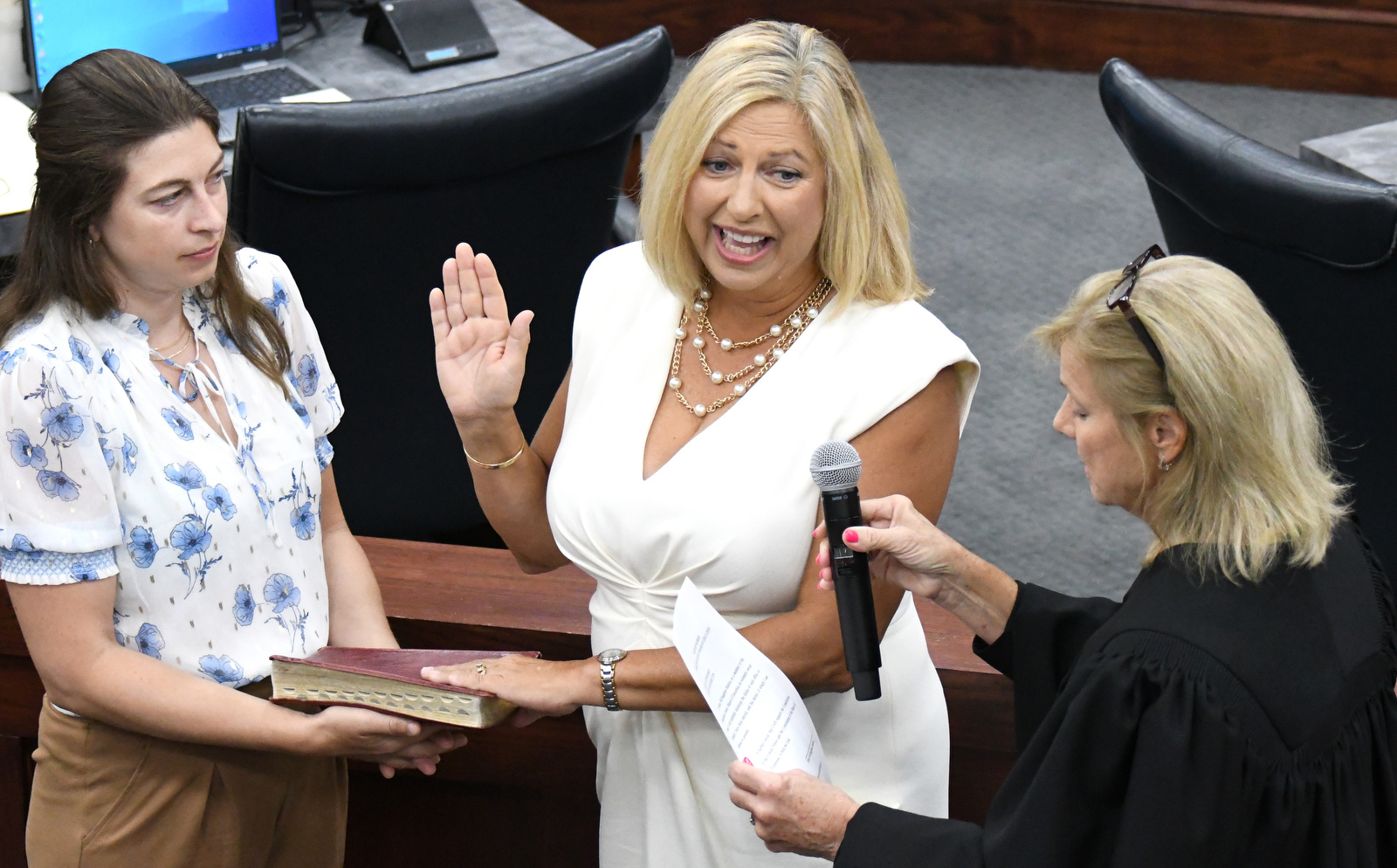 Staff Photo by Robin Rudd / Chancellor Pamela Fleenor, right, administers the oath of office to Felice Hadden, as daughter, Brooke Hadden holds the Bible. The six members of the Hamilton County school board who were elected in August were sworn in and administered their Oaths of Office on September 4, 2024. The members were Steve Slater, Ben Daugherty, Jackie Anderson-Thomas, Jodi Schaffer, Felice Hadden and Jill Black.