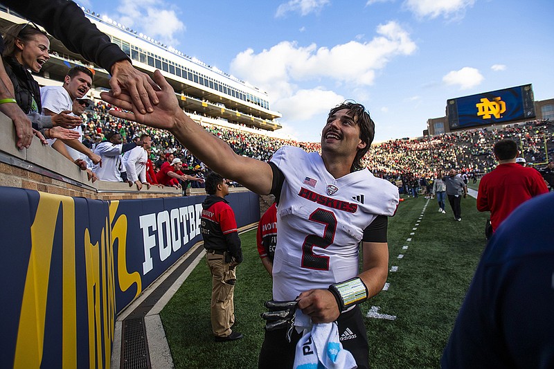 AP photo by Michael Caterina / Northern Illinois quarterback Ethan Hampton celebrates with fans after the Huskies beat No. 5 Notre Dame on Saturday in South Bend, Ind.