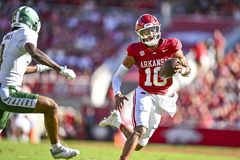 Arkansas quarterback Taylen Green (10) rushes for a touchdown as Alabama-Birmingham defensive back Tyjon Jones (4) pursues during the second quarter at Donald W. Reynolds Razorback Stadium in Fayetteville on Saturday, Sept. 14, 2024. (NWA Democrat-Gazette/Hank Layton)