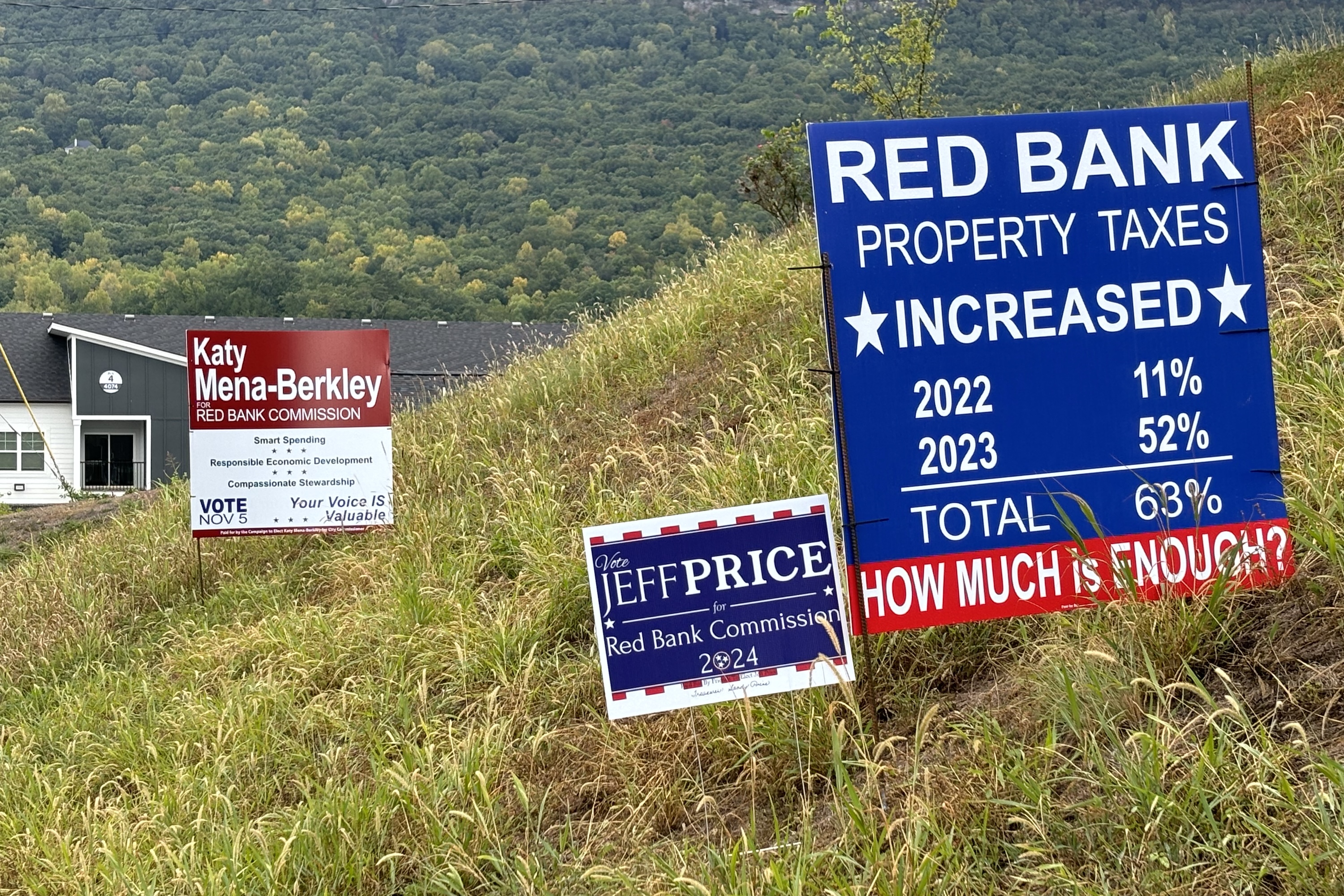 Staff photo by Emily Crisman / Campaign signs for Red Bank City Commission candidates Katy Mena-Berkley and Jeff Price sit alongside a sign highlighting the city's most recent property tax rate increases on Morrison Springs Road in Red Bank.