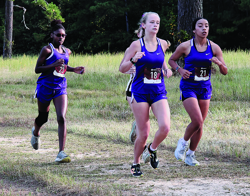 El Dorado's Abby Mitchell (18), Sarahi Rodriguez (21) and Abri White (23) compete in the Wildcat Invitational this season at South Arkansas Regional Airport.