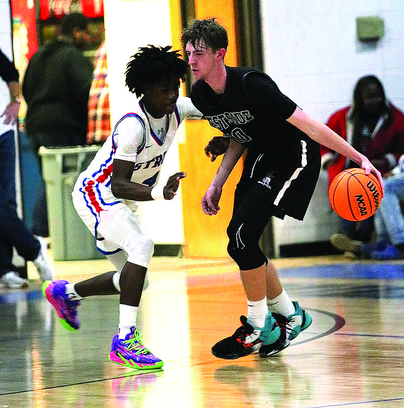 West Side Christian's Nathan Pearson tries to get around a defender at Strong last season. Pearson and the Warriors will open the basketball season Thursday at home against Stephens Christian.