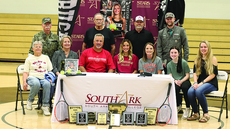 Taylor Darden, surrounded by her family, signed to play tennis at South Arkansas College Friday morning at Smackover's gymnasium.