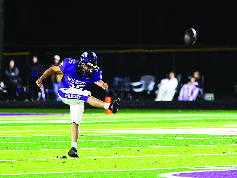 El Dorado's Eric Flores kicks off during Friday's playoff game against Russellville at Memorial Stadium. The freshman kicked off and booted a pair of extra points in the Wildcats' 38-31 victory.