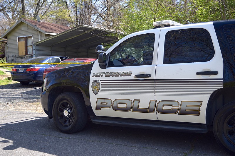 A Hot Springs police patrol unit is shown outside a residence cordoned off by police line tape in 2023. (The Sentinel-Record/Donald Cross/File)