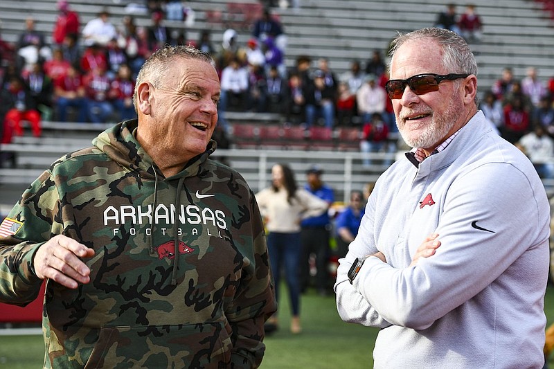 Arkansas coach Sam Pittman (left) and athletics director Hunter Yurachek speak prior to a game against Louisiana Tech on Saturday, Nov. 23, 2024, in Fayetteville. (Hank Layton/NWA Democrat-Gazette)