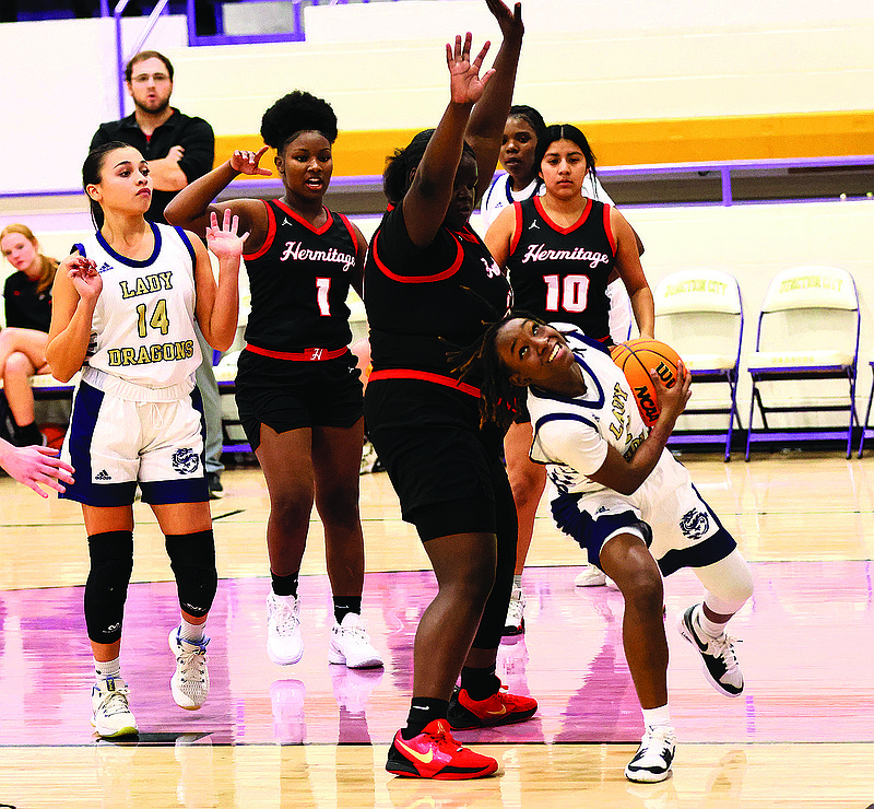 Junction City's Keynizha Moore drives under the basket against Hermitage as teammate Karla Castillo (14) looks on. The Lady Dragons play at Gurdon Tuesday, at home against Harmony Grove on Thursday and at Poyen on Friday.