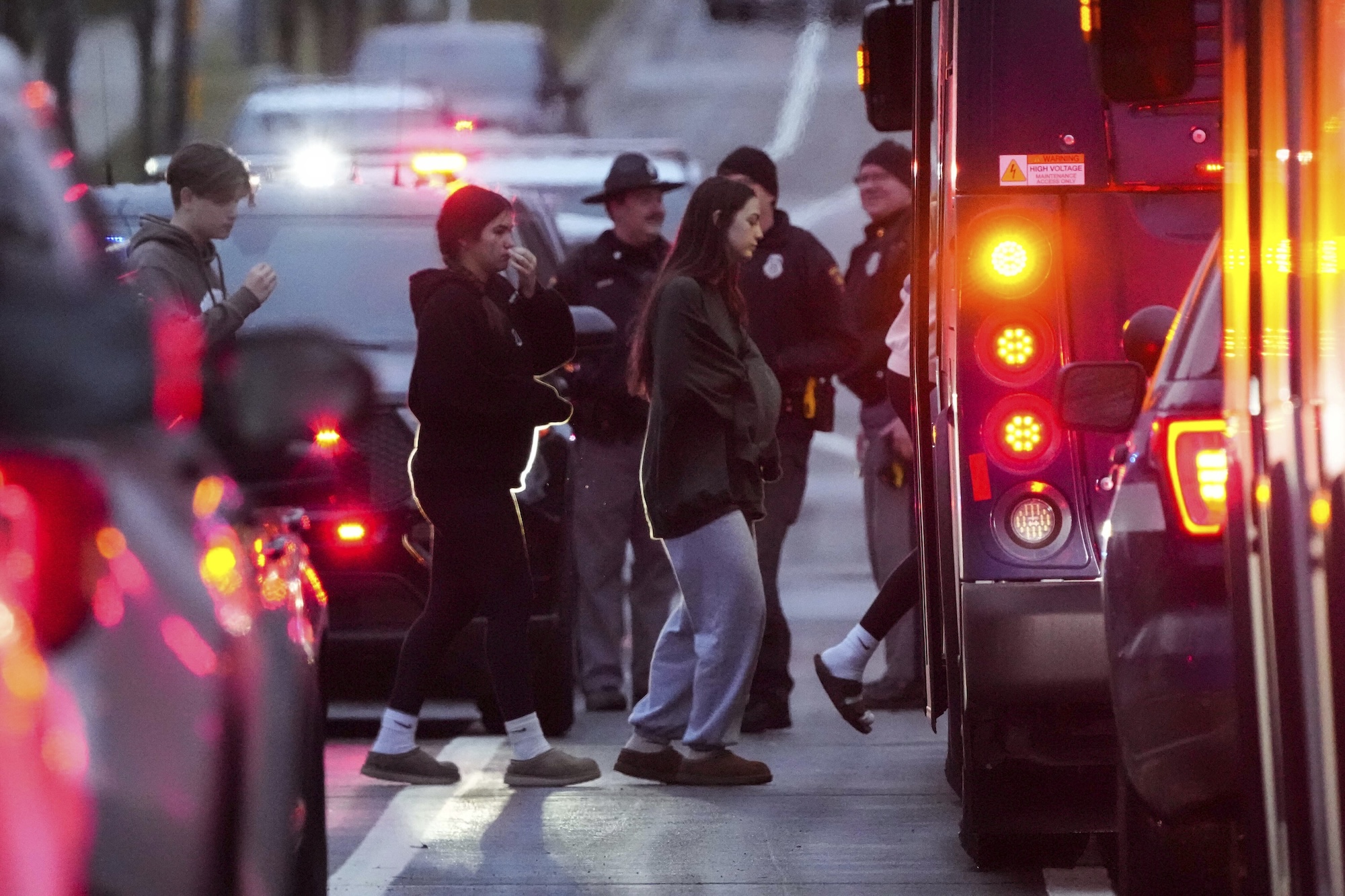 Students aboard a bus as they leave the shelter following a shooting at the Abundant Life Christian School, Monday, Dec. 16, 2024. (AP Photo/Morry Gash)