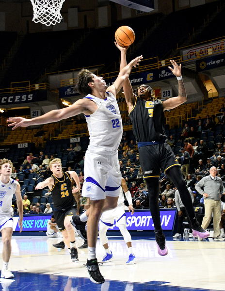 Staff Photo by Robin Rudd / UTC’s Frank Champion (5) shoots over Wesleyan’s Amando Caurdado (22). The University of Tennessee at Chattanooga Mocs hosted the Tennessee Wesleyan Bulldogs at McKenzie Arena on December 18, 2024.