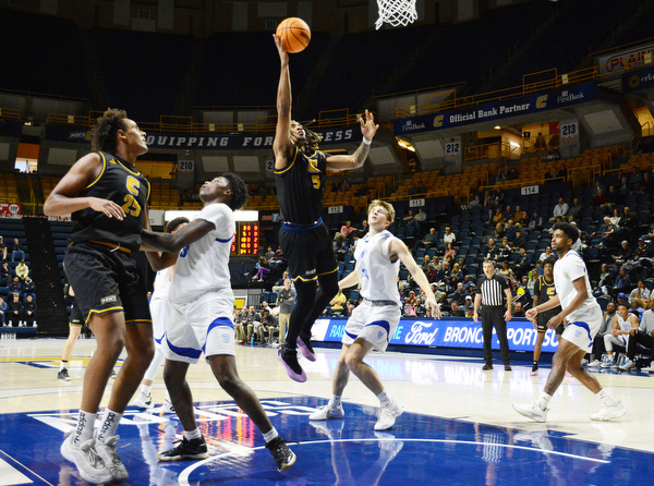 Staff Photo by Robin Rudd / UTC’s Frank Champion (5) shoots under the basket. The University of Tennessee at Chattanooga Mocs hosted the Tennessee Wesleyan Bulldogs at McKenzie Arena on December 18, 2024.