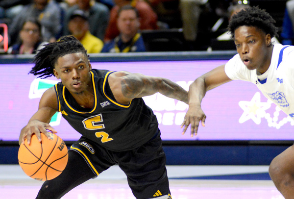 Staff Photo by Robin Rudd / UTC’s Trey Bonham (2) dribbles past a Bulldog defender. The University of Tennessee at Chattanooga Mocs hosted the Tennessee Wesleyan Bulldogs at McKenzie Arena on December 18, 2024.