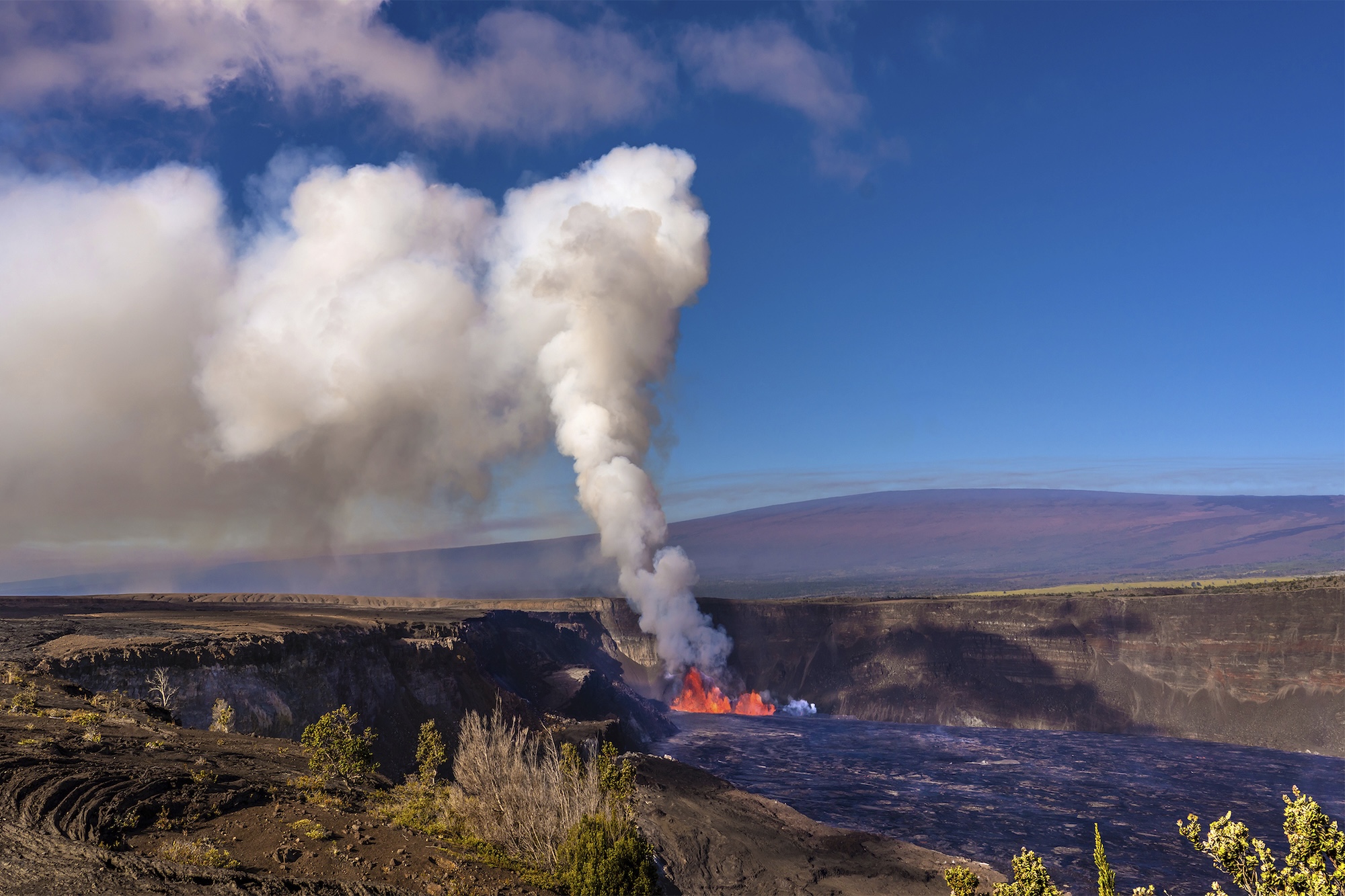 In this photo provided by the National Park Service, an eruption takes place on the summit of the Kilauea volcano in Hawaii, Monday, Dec. 23, 2024. (Janice Wei/NPS via AP)