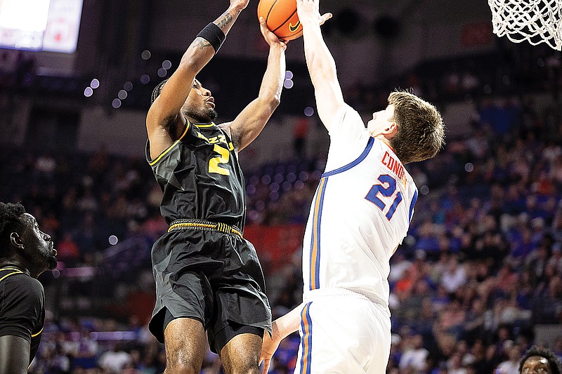 In this Feb. 28, 2024, file photo, Missouri’s Tamar Bates tries to avoid the block attempt of Florida’s Alex Condon during a game in Gainesville, Fla. Bates and the Tigers will face Condon and the Gators tonight. (Associated Press)