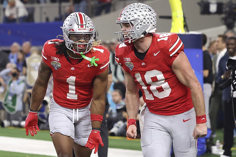 AP photo by Gareth Patterson / Ohio State running back Quinshon Judkins (1) celebrates with quarterback Will Howard after scoring a touchdown against Texas during the College Football Playoff's Cotton Bowl semifinal last Friday at AT&T Stadium in Arlington, Texas.