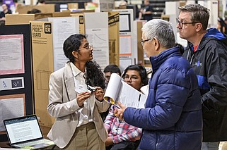 Central High School student Ruthika Matapathi (left) talks about her 3D printed splint with judges Junzuo Wang (middle) and Joel Spencer during Little Rock Central High’s STEM Fair on Friday in the school’s gymnasium..(Arkansas Democrat-Gazette/Staci Vandagriff)