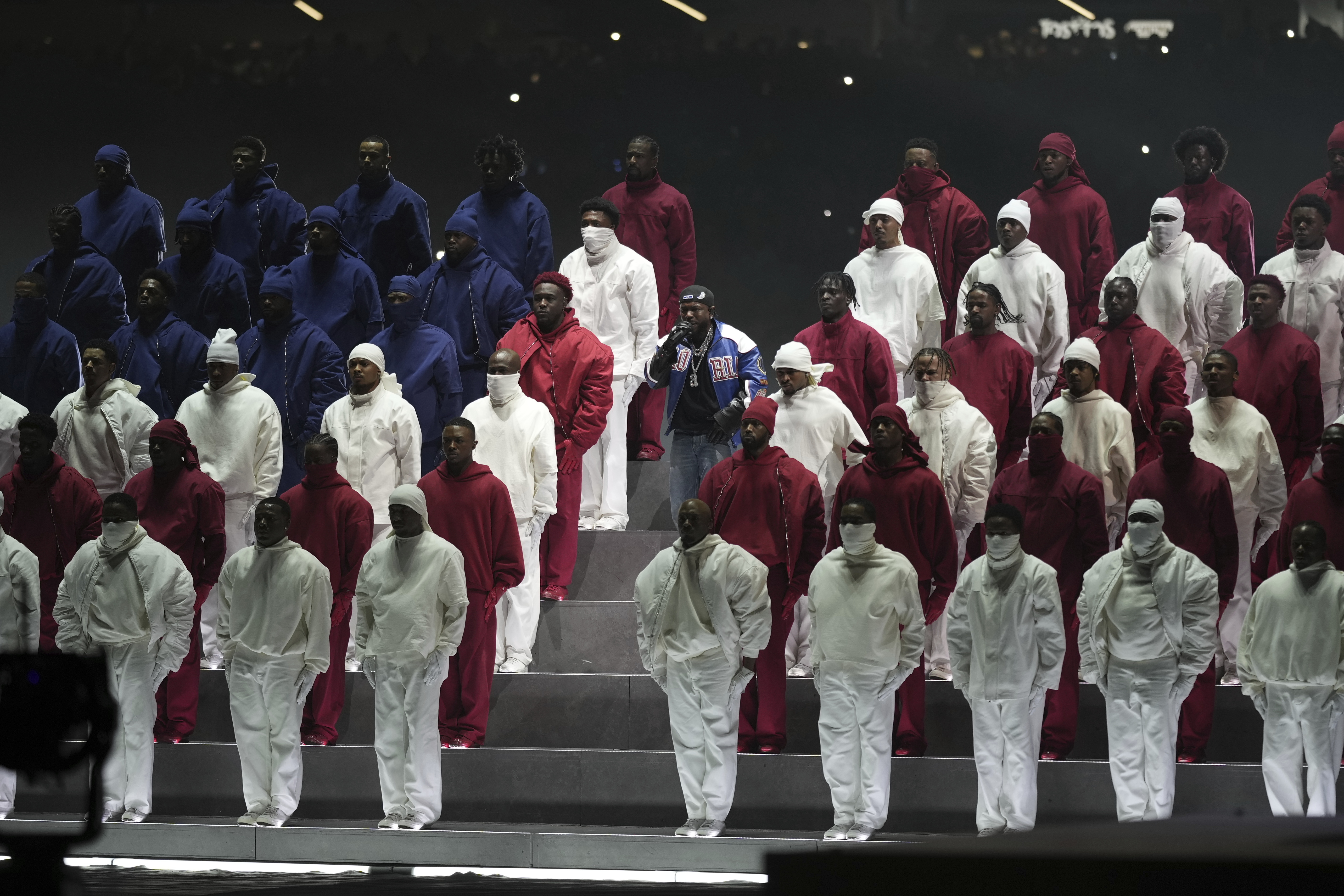 Kendrick Lamar, center, performs during halftime of the NFL Super Bowl 59 football game between the Kansas City Chiefs and the Philadelphia Eagles, Sunday, Feb. 9, 2025, in New Orleans. (AP Photo/Matt Slocum)