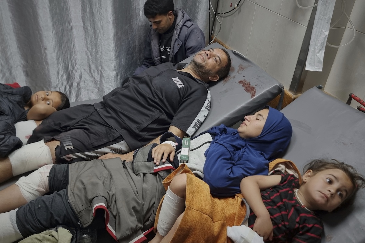 Injured Palestinians wait for treatment at the hospital following Israeli army airstrikes in Khan Younis, southern Gaza Strip, Tuesday, March 18, 2025. (AP Photo/Mohammad Jahjouh)