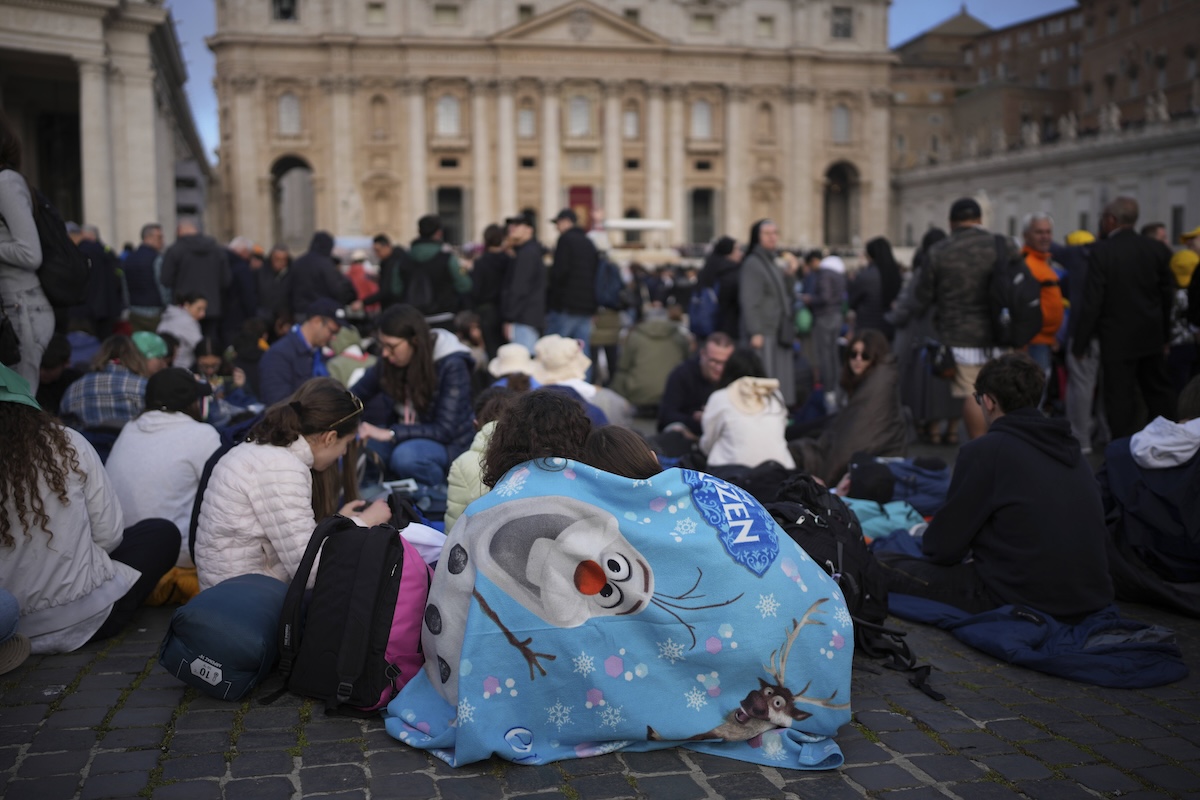 Faithful wait for the start of the funeral of Pope Francis in St. Peter's Square at the Vatican, Saturday, April 26, 2025. (AP Photo/Emilio Morenatti)