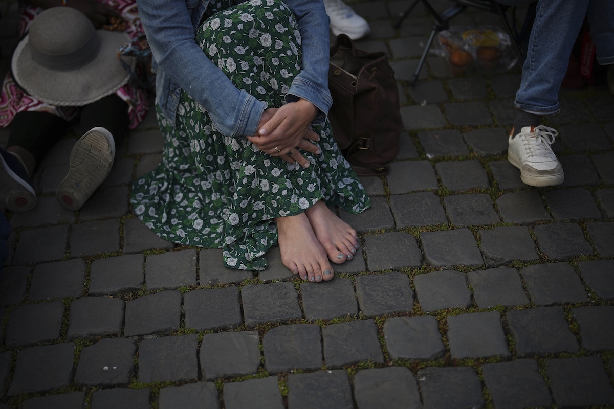 Nadine, from Germany, is waiting for the funeral of Pope Francis to begin, in St. Peter's Square at the Vatican, Saturday, April 26, 2025. (AP Photo/Emilio Morenatti)