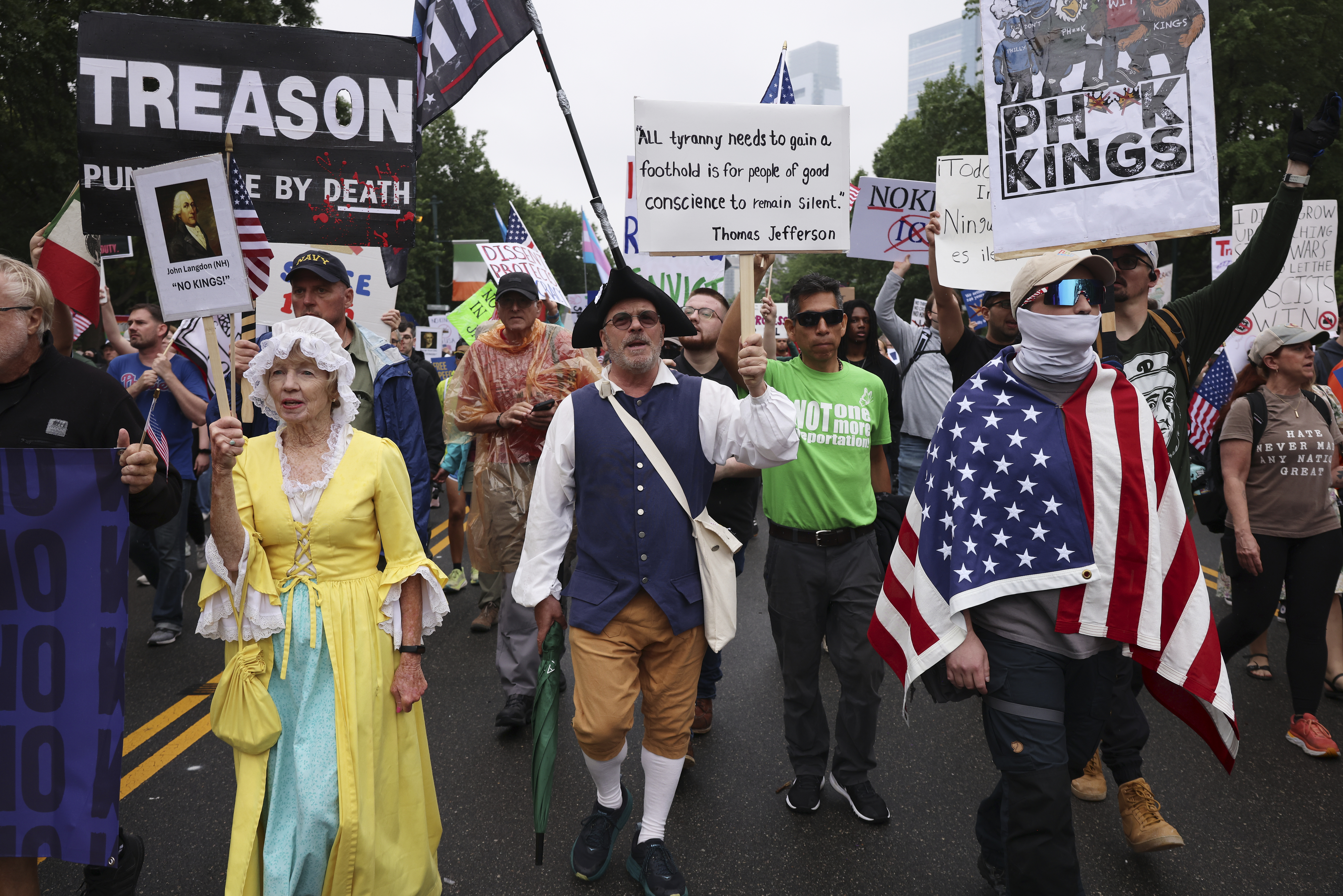 Demonstrators dressed in Revolutionary War era clothing march down Benjamin Franklin Parkway during the "No Kings" protest, Saturday, June 14, 2025, in Philadelphia. (AP Photo/Yuki Iwamura)
