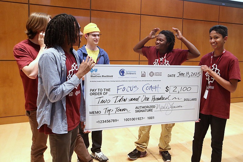 Members of the Focus Coach team celebrate after winning a competition at the AI and Mental Health Hackathon at the University of Arkansas at Little Rock on Friday, June 13, 2025. Team members include (clockwise from front left) Leelin Johnson, James Dempsey, Aiden Behler, Duron Huggins and Anay Pandit. (Arkansas Democrat-Gazette/Thomas Metthe)