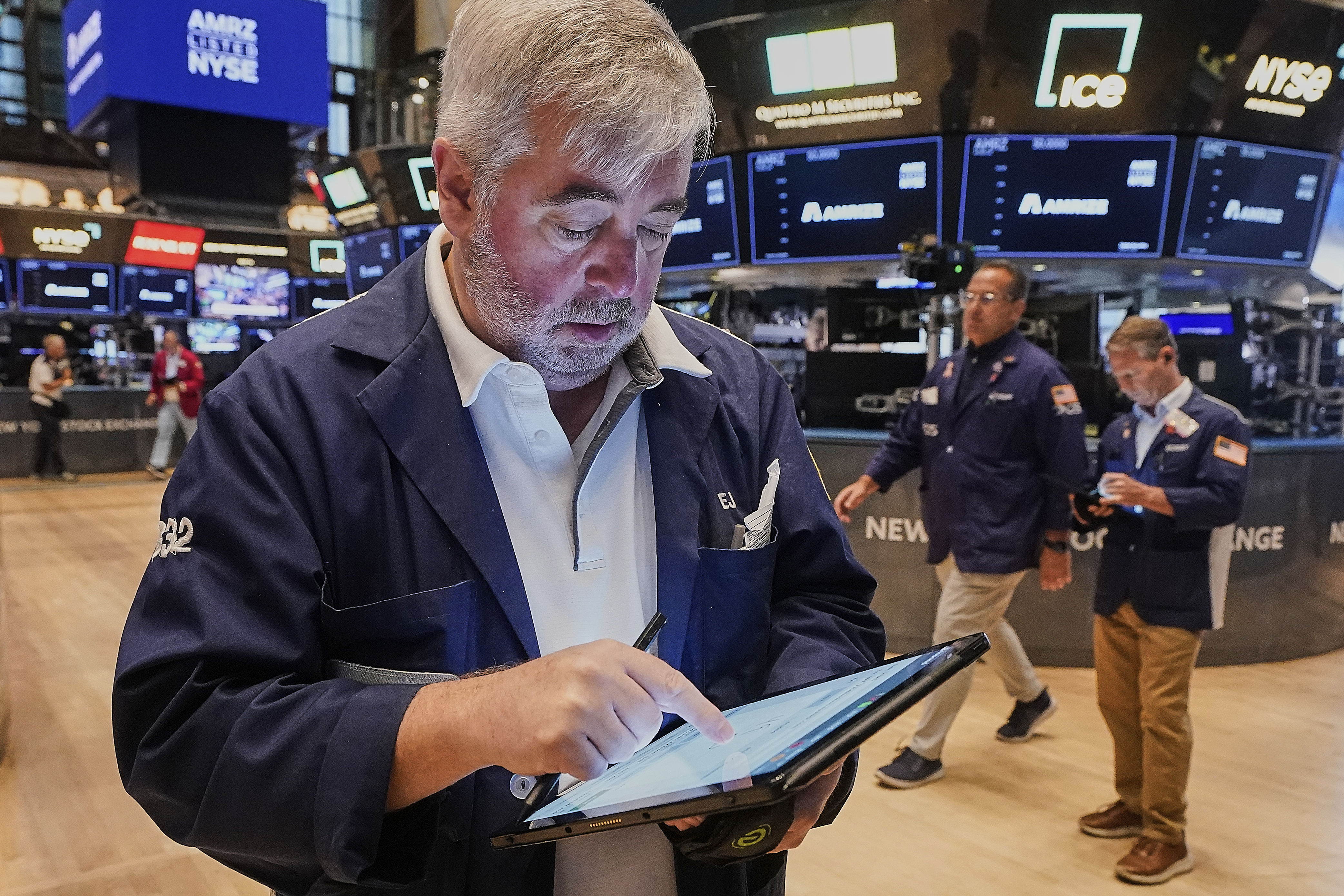 Trader Edward McCarthy, left, works on the floor of the New York Stock Exchange, Monday, June 23, 2025. (AP Photo/Richard Drew)