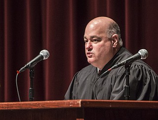 U.S. District Judge Timothy L. Brooks oversees naturalization proceedings for the Western District of Arkansas at the Pat Walker Theater at Springdale High School in this Sept. 16, 2016, file photo. (NWA Democrat-Gazette file photo)