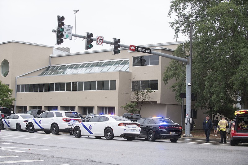 Law enforcement and emergency personnel stage near the law school at the University of Arkansas in Fayetteville after reports of an active shooter near the library. Visit nwaonline.com/photo for today's photo gallery. (NWA Democrat-Gazette/J.T. Wampler) ..