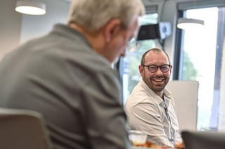 Aaron Duvall (right), then the career and technical education director for Premier High School in Fort Smith, visits with other secondary career center technical directors during a lunch and tour hosted by the University of Arkansas-Fort Smith Center for Economic Development at the Bakery District in downtown Fort Smith in this Nov. 9, 2022, file photo. Duvall, who in April 2025 became the head of the Workforce Development Center at the University of Arkansas at Little Rock, has hailed the university's plans to offer courses in artificial intelligence, saying, "The No. 1 skill businesses want (in workers) is AI â€” itâ€™s all about the skills people have." (NWA Democrat-Gazette/Hank Layton)