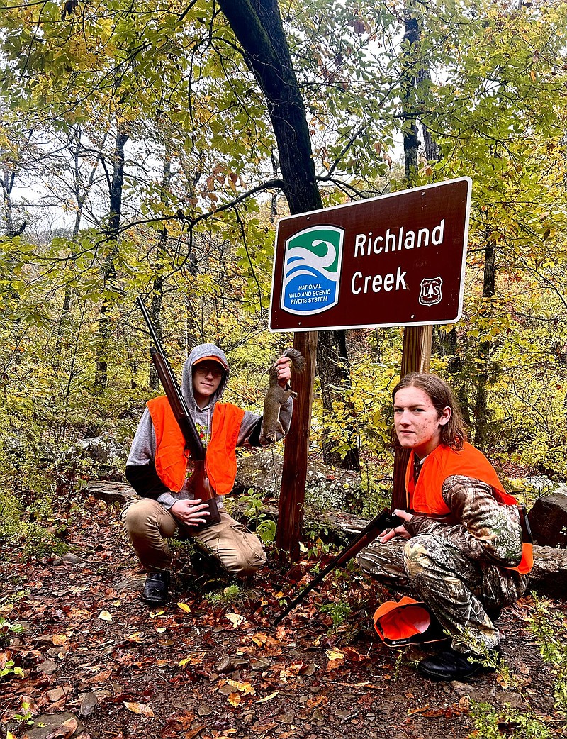 Carson Kelly (left) bagged his first squirrel while hunting with his brother, Grayson Kelly, in the Ozark National Forest. (Arkansas Democrat-Gazette/Bryan Hendricks)