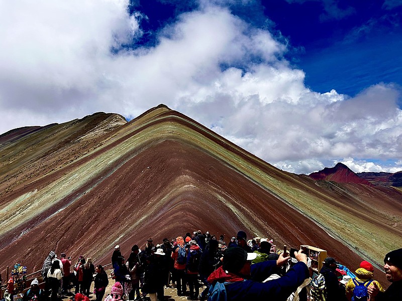 Pilgrims celebrated when the fog broke to reveal the splendor of Peru’s Rainbow Mountain, elevation 16,522 feet. (Arkansas Democrat-Gazette/Bryan Hendricks)
