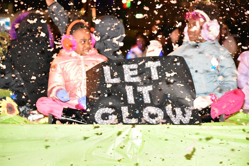 Children on a parade float remind attendees to
