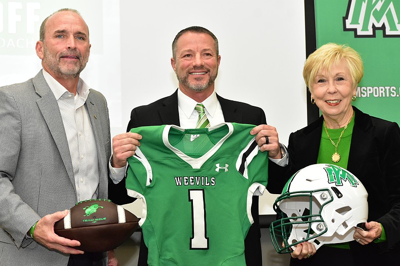 New University of Arkansas at Monticello football Coach Gary Goff receives a jersey from former coach and Athletic Director Hud Jackson and Chancellor Peggy Doss during his introductory news conference Thursday, Dec. 11, 2025, at the UAM Student Success Center. (Pine Bluff Commercial/I.C. Murrell)