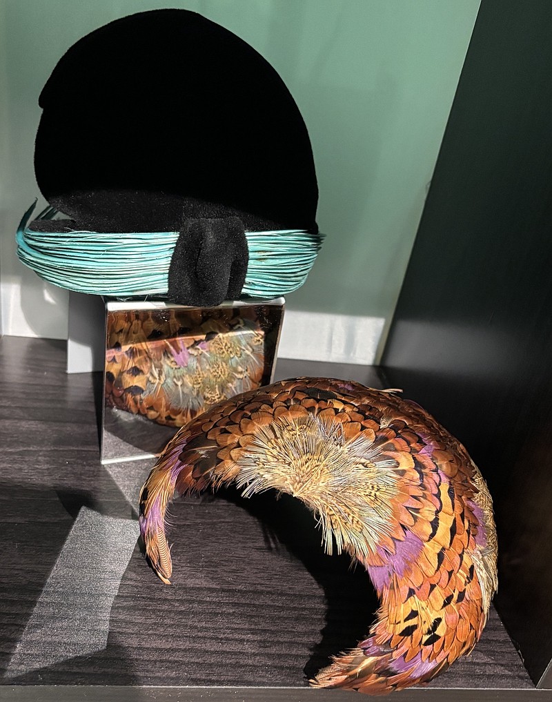 While researching objects for the exhibit, Bynum discovered that the black and teal hat pictured here is a Schiaparelli, created by a famous Italian designer between 1927 and 1954. A feather hat is also on display.
(Courtesy Photo)