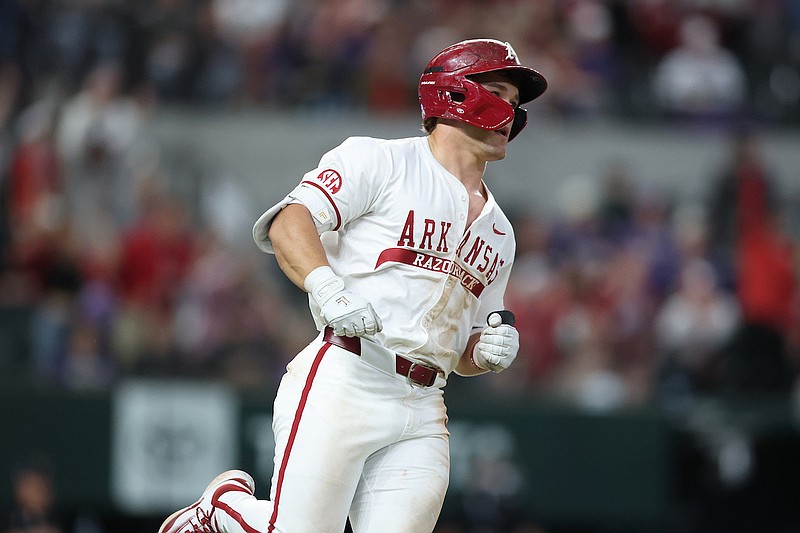 Arkansas Razorbacks second baseman Camden Kozeal rounding the bases after hitting a game-tying home run in the ninth inning.