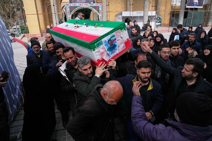 The coffin of Mehdi Hosseini, a man killed in a U.S.-Israeli strike, is carried for burial at Behesht-e Zahra cemetery in Tehran, Iran, Monday, March 9, 2026. (AP Photo/Vahid Salemi)