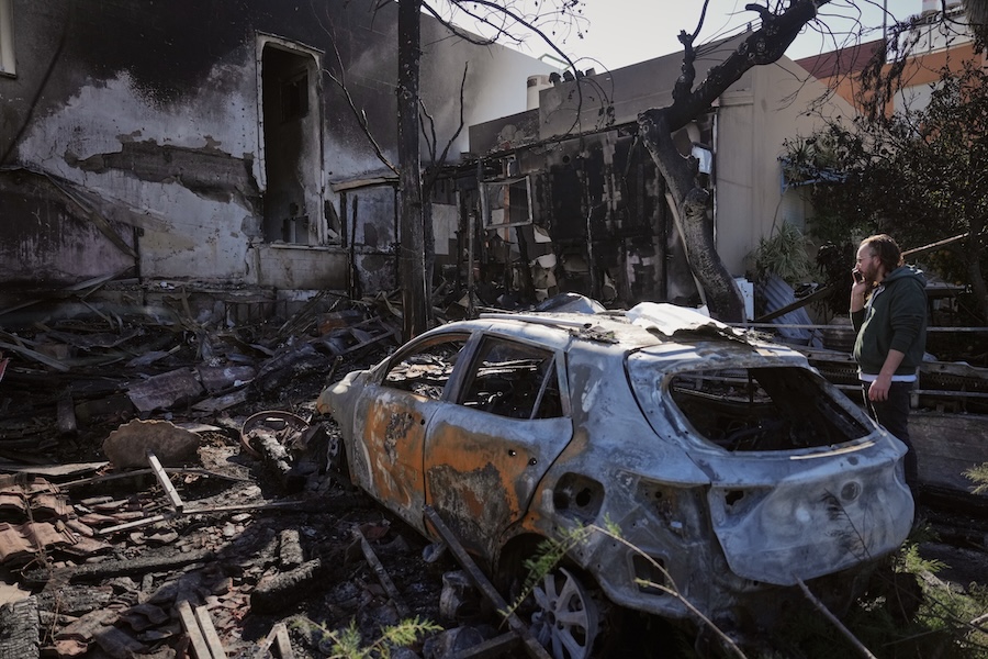 Residents inspect a house damaged yesterday by a projectiles launched from Lebanon in Nahariya, northern Israel, Tuesday, March 17, 2026. (AP Photo/Ariel Schalit)