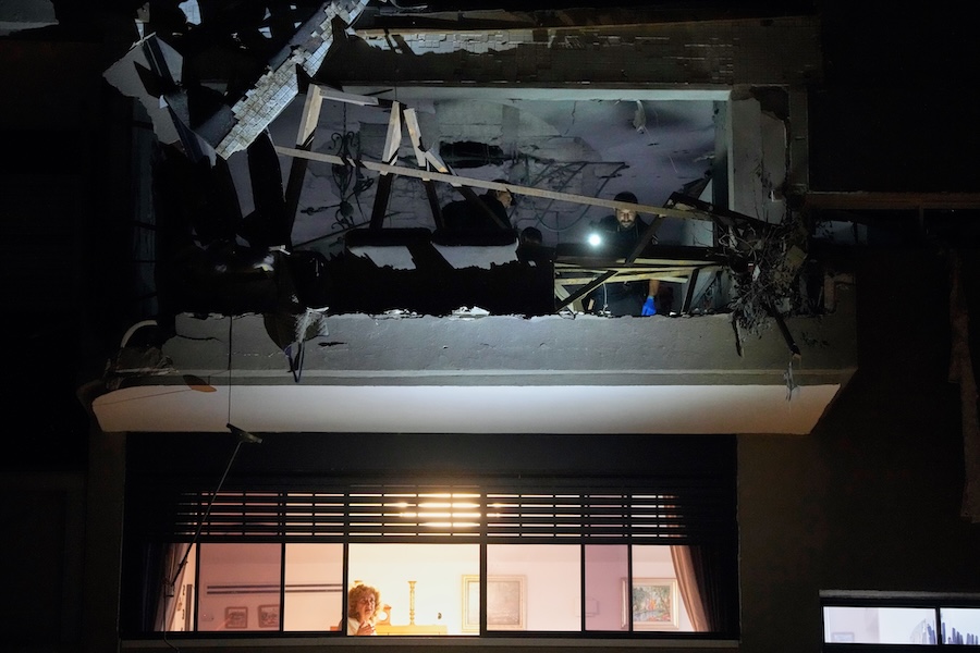 Israeli security forces inspect an apartment struck by an Iranian missile that killed two people in Ramat Gan, Israel, Wednesday, March 18, 2026. (AP Photo/Ohad Zwigenberg)