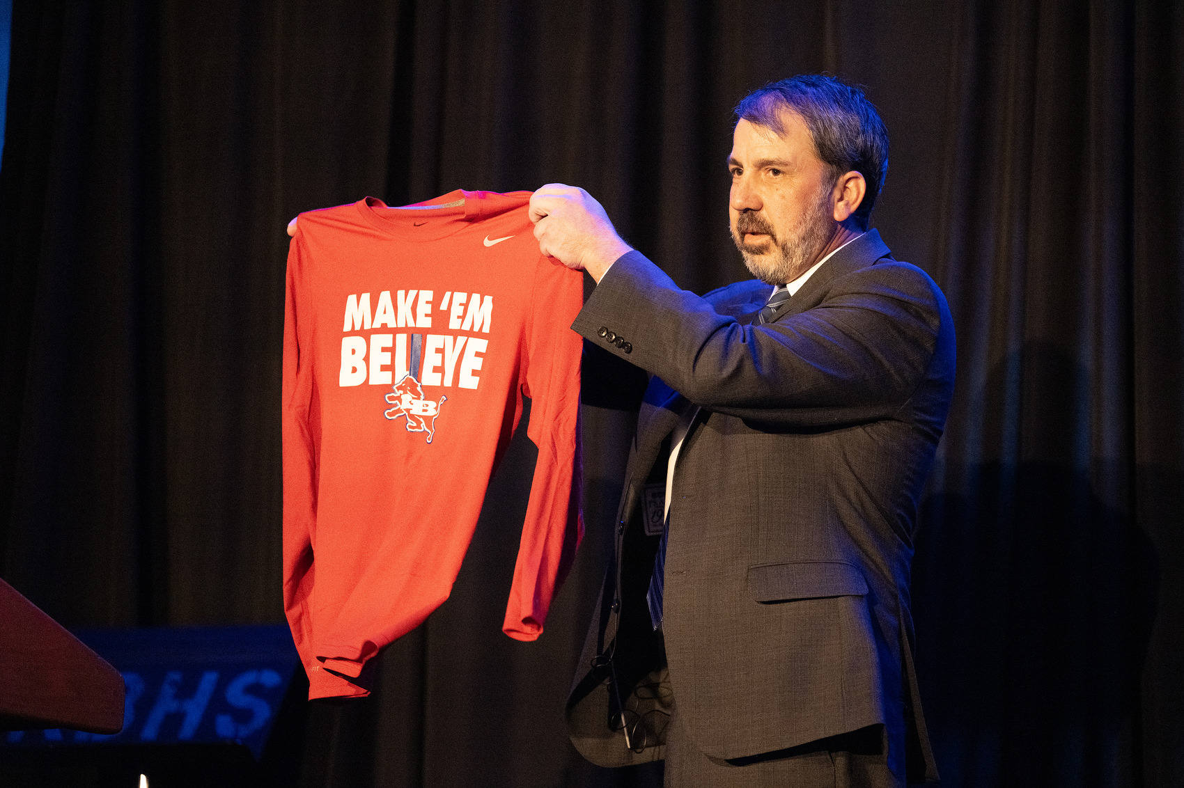 Staff Photo by Seth Carpenter/ Superintendent Justin Robertson holds up a Red Bank High School shirt that reads “Make 'em believe” during the State of the System.