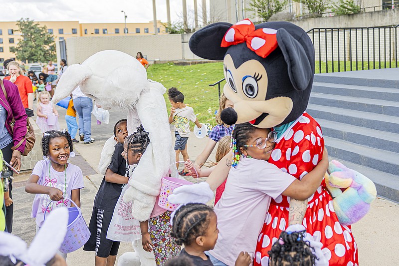 Children line up for hugs and photos with the Easter Bunny and Minnie Mouse. (Pine Bluff Commercial/I.C. Murrell)